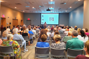 Group of people in an audience looking at the presenter