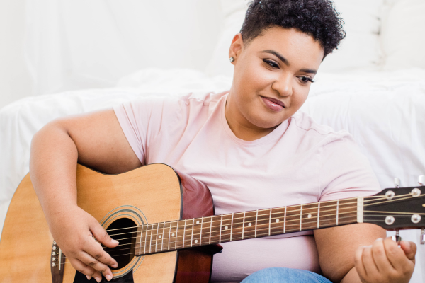 Woman playing an acoustic guitar