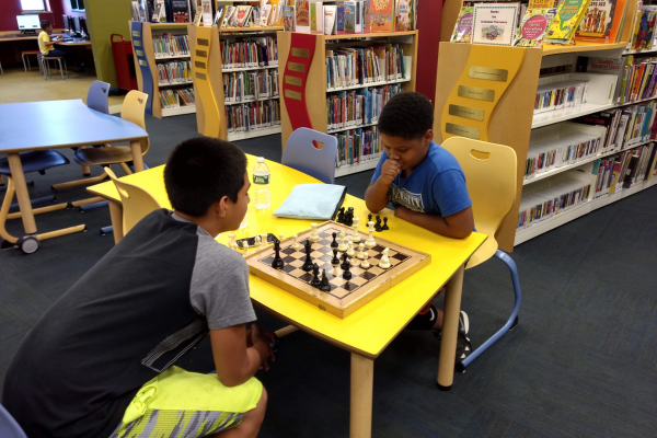 Kids p[laying chess at Adriance Kids playing chess at Adriance