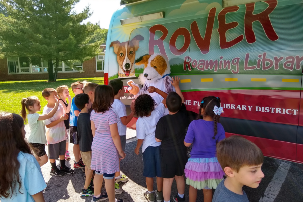 Rover Bookmobile and Masoct visit a school Rover Bookmobile and Mascot visit a school
