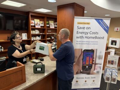 Patron receiving free Home Energy Savings Kit after returning the HomeBoost assessment toolkit.