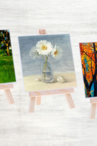 Tiny Art Show Mini artworks on tiny easels. The main piece depicts a vase with daisies in it.