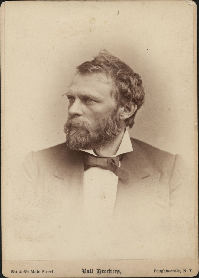 Black-and-white profile portrait of a bearded man, Harvey Eastman in formal attire with a bow tie, showcasing a thoughtful expression.